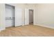 Empty bedroom with wood-look flooring and large walk-in closet at 21406 E Mewes N Rd, Queen Creek, AZ 85142