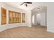 Empty bedroom with wood-look flooring, wood shutters, and an arched doorway at 21406 E Mewes N Rd, Queen Creek, AZ 85142