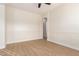 Empty bedroom with wood-look floors, chair rail molding, and arched doorway at 21406 E Mewes N Rd, Queen Creek, AZ 85142