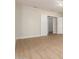 Empty bedroom with wood-look flooring, white walls, and open doorways at 21406 E Mewes N Rd, Queen Creek, AZ 85142