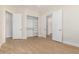 Bedroom featuring wood-look flooring, closet with built-in shelving, and open doorways at 21406 E Mewes N Rd, Queen Creek, AZ 85142