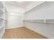 Walk-in closet with built-in shelving and hanging rods at 21406 E Mewes N Rd, Queen Creek, AZ 85142