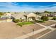 Elevated view of a single-story home with landscaping, a three-car garage, and a pond at 21406 E Mewes N Rd, Queen Creek, AZ 85142