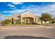 Front exterior of a single-story house featuring stone accents, lush landscaping, and an arched entryway at 21406 E Mewes N Rd, Queen Creek, AZ 85142