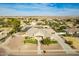 Aerial view of a single-story home with a pond, landscaping, and a three-car garage at 21406 E Mewes N Rd, Queen Creek, AZ 85142