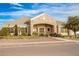 Front exterior of a single-story house showcasing stone accents, a landscaped yard, and an arched entryway at 21406 E Mewes N Rd, Queen Creek, AZ 85142
