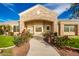 Stone and stucco exterior with a welcoming front walkway lined with roses at 21406 E Mewes N Rd, Queen Creek, AZ 85142