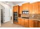 Kitchen with wood cabinetry, stainless steel appliances, pantry access and tile backsplash at 21406 E Mewes N Rd, Queen Creek, AZ 85142