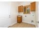 Laundry room with utility sink and wooden cabinetry at 21406 E Mewes N Rd, Queen Creek, AZ 85142