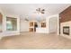 Open-concept living area with wood-look floors, a fireplace, and a view of the kitchen at 21406 E Mewes N Rd, Queen Creek, AZ 85142