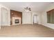 Living room with wood-look flooring, a fireplace with wood accent wall, and arched doorways at 21406 E Mewes N Rd, Queen Creek, AZ 85142