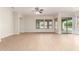Bright living room with large windows, wood-look flooring, and a sliding glass door at 21406 E Mewes N Rd, Queen Creek, AZ 85142