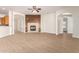 Inviting living room with wood-look flooring, a fireplace, and arched doorways at 21406 E Mewes N Rd, Queen Creek, AZ 85142