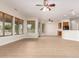 Open living area with wood-look flooring, lots of windows, and views to kitchen and backyard at 21406 E Mewes N Rd, Queen Creek, AZ 85142
