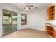 Home office or den with wood-look flooring, built-in cabinetry, and sliding glass door at 21406 E Mewes N Rd, Queen Creek, AZ 85142