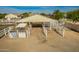 Outbuilding with covered area, fenced pens, and additional storage space at 21406 E Mewes N Rd, Queen Creek, AZ 85142