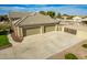 Three-car garage with a paved driveway and gated entry at 21406 E Mewes N Rd, Queen Creek, AZ 85142
