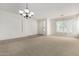 Bright living room featuring a chandelier and carpet at 2191 E Bellerive Pl, Chandler, AZ 85249