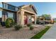 Two-story home with red door, brick accents, and landscaping at 23451 S 228Th St, Queen Creek, AZ 85142