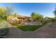 Landscaped backyard with pool, artificial turf, and patio at 25410 N 46Th Ln, Phoenix, AZ 85083