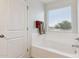 Bathroom with soaking tub and window with blinds at 2924 N Taylor Ln, Casa Grande, AZ 85122