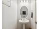 Small bathroom with pedestal sink and oval mirror at 2924 N Taylor Ln, Casa Grande, AZ 85122