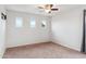Bright bedroom with carpet flooring and three windows at 2924 N Taylor Ln, Casa Grande, AZ 85122