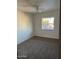 Bright bedroom with carpeted floors and a window at 334 W Horseshoe Ave, Gilbert, AZ 85233