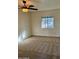 Bright bedroom with ceiling fan and carpeted floor at 334 W Horseshoe Ave, Gilbert, AZ 85233