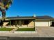 Ranch style home with green roof, attached garage, and well-manicured lawn at 334 W Horseshoe Ave, Gilbert, AZ 85233