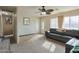 Inviting living room with a ceiling fan, plush carpeting, and ample natural light at 4238 W Krall St, Phoenix, AZ 85019