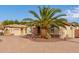 Mediterranean style home with a palm tree and brick driveway at 4599 N Village Pkwy, Litchfield Park, AZ 85340