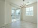 Dining area with sliding door to balcony and modern chandelier at 4728 E Waterman St # 101, Gilbert, AZ 85297