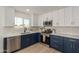 Modern kitchen with blue and white cabinets, and stainless steel appliances at 499 S Washington St, Chandler, AZ 85225