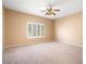Spacious bedroom with plush carpet and a ceiling fan at 5217 S Crested Saguaro Ln, Gold Canyon, AZ 85118