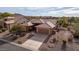 Elevated view of single-story home with tile roof, two-car garage, and desert landscaping at 5217 S Crested Saguaro Ln, Gold Canyon, AZ 85118