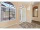 Bright foyer with arched windows, tile flooring, and a view of the front door at 5217 S Crested Saguaro Ln, Gold Canyon, AZ 85118