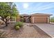 Inviting single-story home with desert landscaping and attached two-car garage at 5217 S Crested Saguaro Ln, Gold Canyon, AZ 85118