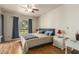 Spacious bedroom with king-size bed, wood flooring, and backyard view at 8651 E Royal Palm Rd # 105, Scottsdale, AZ 85258