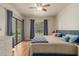 King-size bed, wood flooring, and sliding glass doors leading to a patio at 8651 E Royal Palm Rd # 105, Scottsdale, AZ 85258