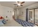 Bedroom with king bed, access to patio, and built-in dresser at 8651 E Royal Palm Rd # 105, Scottsdale, AZ 85258
