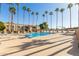 Relaxing community pool area with plenty of lounge chairs and palm trees at 8651 E Royal Palm Rd # 105, Scottsdale, AZ 85258