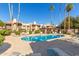 Community pool with surrounding lounge chairs and a spa at 8651 E Royal Palm Rd # 105, Scottsdale, AZ 85258