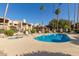 Inviting community pool and spa, surrounded by lounge chairs and landscaping at 8651 E Royal Palm Rd # 105, Scottsdale, AZ 85258