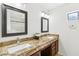 Double vanity bathroom with granite countertops and large mirrors at 9100 E Raintree Dr # 130, Scottsdale, AZ 85260