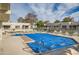 Community pool with blue cover and lounge chairs at 9277 W Jason Dr, Peoria, AZ 85382