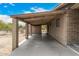 Covered carport area with concrete slab and brick columns at 11020 N 13Th St, Phoenix, AZ 85020