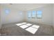 Bright bedroom with neutral carpeting and ample natural light at 14793 W Tether Trl, Surprise, AZ 85387