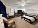 Large bedroom with king-size bed, ample natural light, and rocking chair at 14821 N 51St Dr, Glendale, AZ 85306