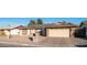 House exterior featuring a two-car garage, solar panels, and landscaped front yard at 14821 N 51St Dr, Glendale, AZ 85306